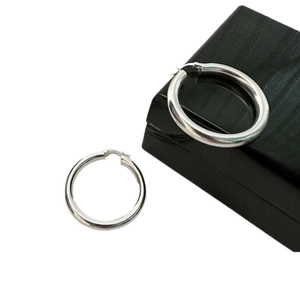 Polished S925 sterling silver hoop earrings with secure clasp on a black gift box