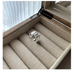 Detailed shot of S925 silver ring with liquid lava texture in a vintage wooden jewelry box