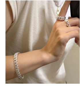 Detail view of S925 sterling silver woven texture Cuban chain bracelet and ring set on hand
