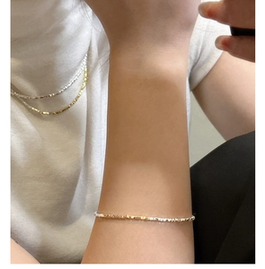 Close-up of S925 sterling silver faceted bracelet with two-tone gold and silver finish