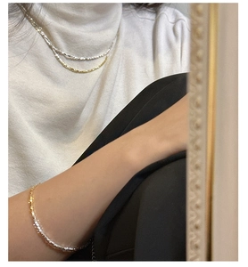 Detail of S925 silver layered necklace and bracelet with sparkling crushed silver finish
