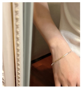 Close-up of minimalist S925 silver bracelet featuring gold and silver dual-tone segments