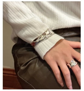 Detail of silver wavy hammered cuff bracelet and matching ring on model wrist