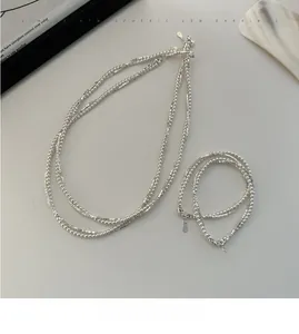 Detailed close-up of S925 sterling silver layered necklace and bracelet set