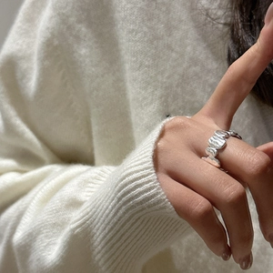 Minimalist S925 sterling silver ring with irregular lava texture shown on index finger