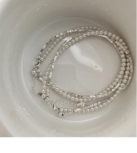 Detail of S925 silver beaded bracelet with white pearls and faceted silver beads