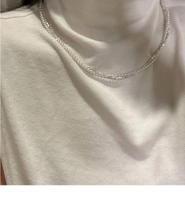 Close-up of double-layer S925 silver necklace with pearls on white sweater