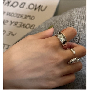 Close-up of a three-piece S925 sterling silver ring set worn on a model's hand