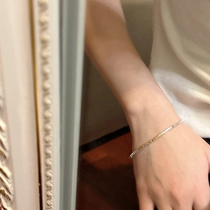 Minimalist S925 silver bracelet in mixed gold and silver tones worn on a wrist