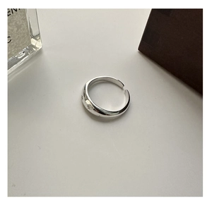 Macro detail of wide S925 silver ring featuring an engraved starburst pattern