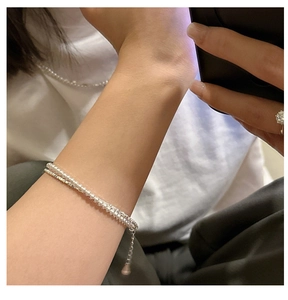Detail of double-layer S925 silver bracelet with pearls and shimmering rhinestones