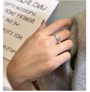 Detailed close-up of a 925 sterling silver star ring on a model index finger