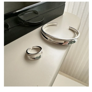 Detailed view of S925 sterling silver open ring and cuff bracelet set with sleek curves