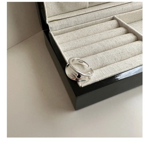 Macro shot of S925 sterling silver stamp on minimalist wide wave ring detail