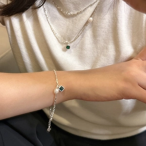 S925 sterling silver necklace and bracelet set with green zircon and pearls on a model