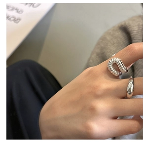 Detailed view of silver rings featuring a spiral spring design and engraved star textures