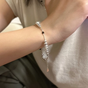 S925 Sterling Silver beaded bracelet featuring black onyx and a heart charm on wrist