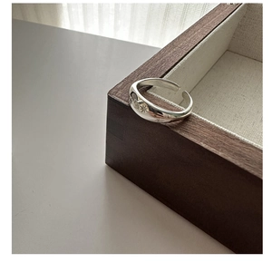 Detailed view of 925 sterling silver ring featuring starburst engravings on wood