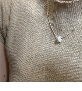 Detail of S925 sterling silver frosted doughnut pendant necklace on a knitted top