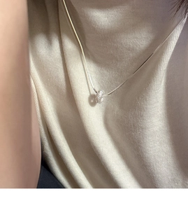 Detail of S925 sterling silver frosted donut pendant on a fine snake chain necklace