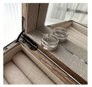 Detailed view of two irregular twisted S925 sterling silver rings in a wooden jewelry box