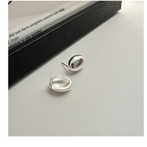 Detailed close-up of S925 sterling silver bean earrings with polished mirror finish