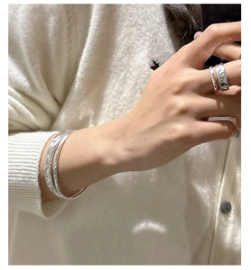 Detail of S925 sterling silver ring and bangles featuring handmade hammered texture finish