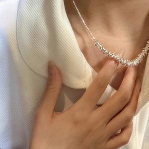 Minimalist S925 sterling silver irregular nugget necklace on model with white shirt