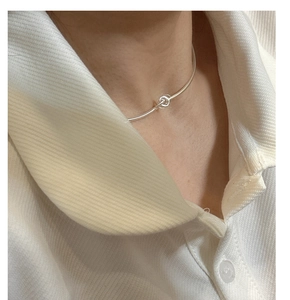 Close-up of a minimalist S925 sterling silver snake chain choker on a female model
