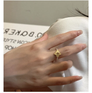 Macro shot of silver and gold floral ring featuring brushed petals and twisted band