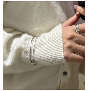 Detail of S925 sterling silver double-layered hammered ring and cuff on a model