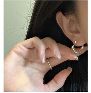 Close-up of polished S925 sterling silver U-shaped hoop earring with a sleek mirror finish