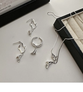 Macro shot of S925 silver jewelry set featuring lily of the valley wavy bud design