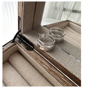 Macro shot of S925 sterling silver wavy layered rings in a vintage wooden jewelry box