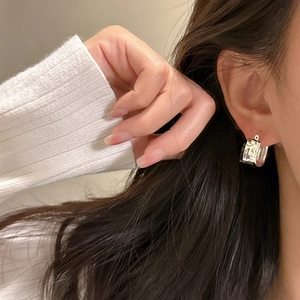 S925 sterling silver hoop earrings with square pleated texture on a female model