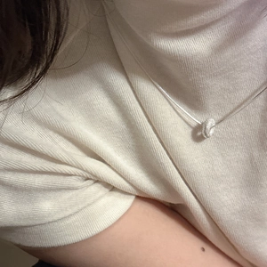 S925 sterling silver doughnut necklace with frosted texture on a white knit sweater