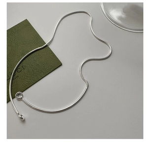 Detailed close-up of a minimalist S925 silver snake chain necklace with high-polish clasp