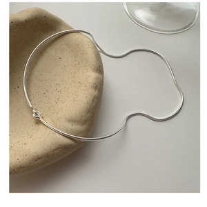 Detail view of minimalist S925 sterling silver snake chain with polished metal bar