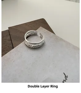 Detailed close-up of a double-layer S925 silver ring with textured and polished bands