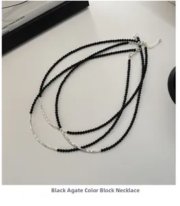 Detail of S925 sterling silver lobster clasp and black agate beads on layered necklace
