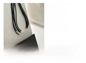 Detailed view of S925 sterling silver chain with black agate beads and polished finish