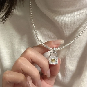 Elegant S925 silver pearl necklace with vintage floral lock pendant shown on model