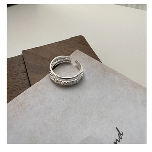 Detail of S925 sterling silver double-layer ring with textured and polished finish surfaces
