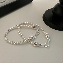 Close-up of S925 silver clasp on high-luster pearl necklace with unique hardware detail
