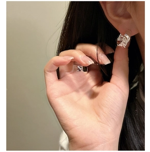Close-up of S925 sterling silver earrings with unique irregular pleated texture design