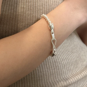 Elegant S925 sterling silver freshwater pearl bracelet with unique clasp on model wrist