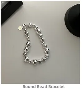 Detail of S925 sterling silver beaded bracelet showing hallmark tag and lobster clasp