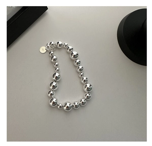 Detail view of S925 sterling silver beaded bracelet with polished gradient metal spheres