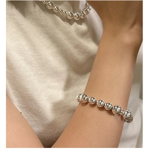 Polished S925 sterling silver bead bracelet and necklace set shown on model