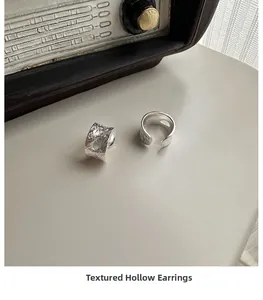Detailed view of S925 sterling silver ear clips with unique textured hammered finish